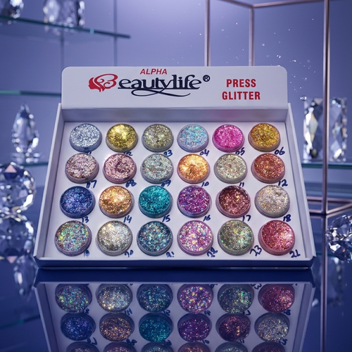 Alpha Beauty Life press glitter palette with colorful glitter balls on a reflective surface.