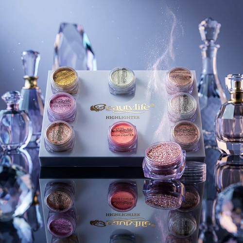 Set of makeup highlighters with a decorative box on a reflective surface.